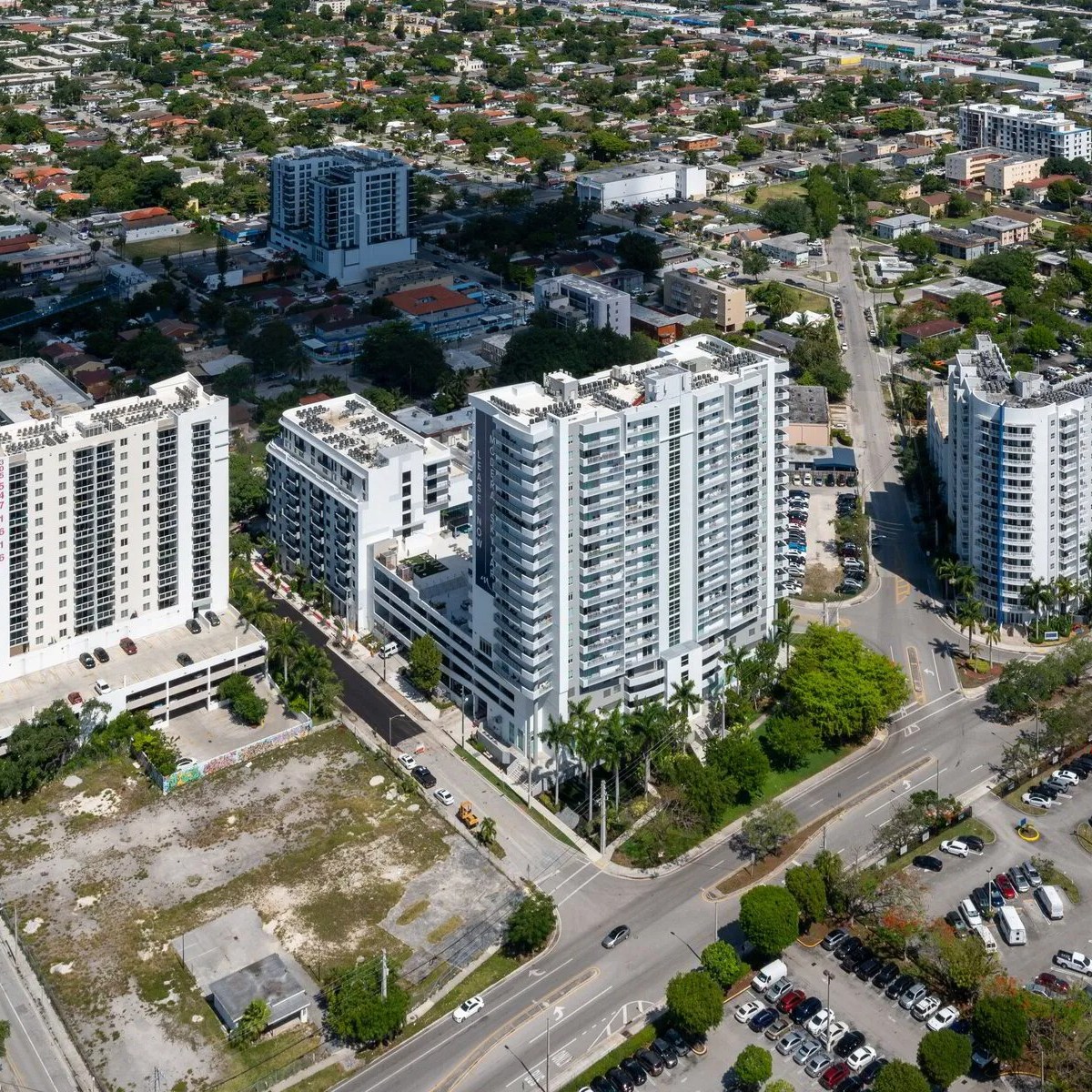 Aerial view of a cityscape with tall residential buildings and surrounding streets.