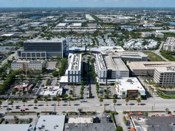 Aerial view of a cityscape with large buildings and roads.